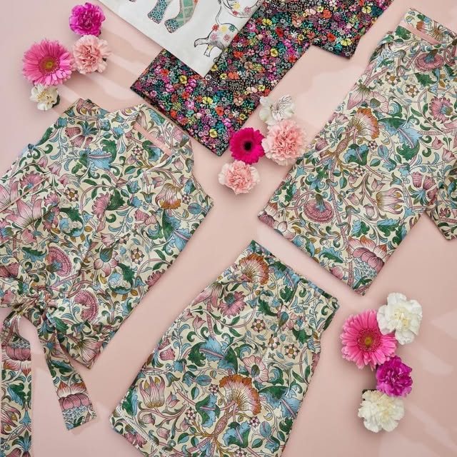 Children's floral pyjama sets laid out with fresh flowers